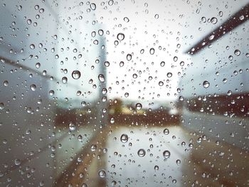 Full frame shot of wet glass window in rainy season