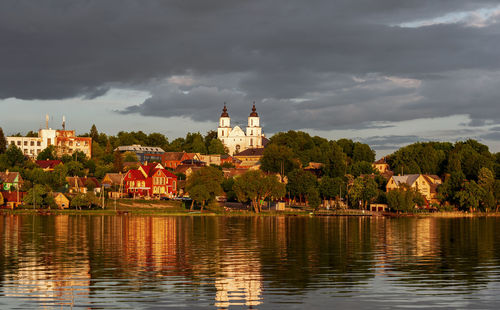 Panoramic view of lake and buildings against sky