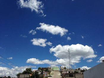 Low angle view of buildings against blue sky