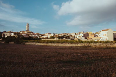 Houses on landscape against sky