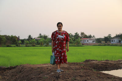 Portrait of women standing on field against clear sky