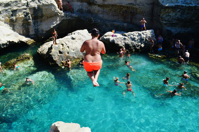 Group of people swimming in sea