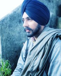 Young man wearing turban looking away