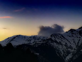 Scenic view of snow covered mountains against sky