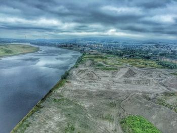 Aerial view of landscape against cloudy sky