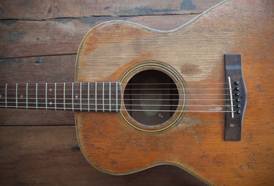 High angle view of guitar on wooden table