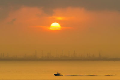 Scenic view of sea against orange sky