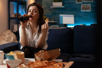 Portrait of young woman having food