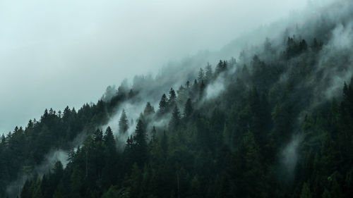 Scenic view of mountains against cloudy sky