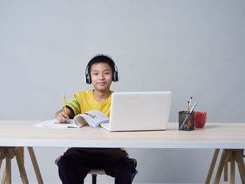 Portrait of man sitting on chair at table