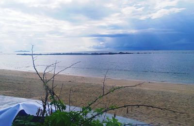 Scenic view of sea against cloudy sky