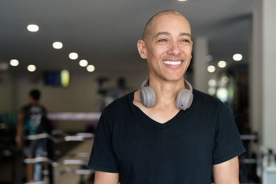 Portrait of young man standing against illuminated lights