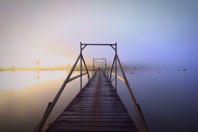 Wooden bridge in a foggy day