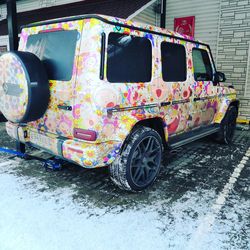 Graffiti on old car parked on street