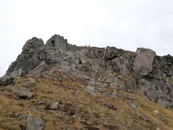 Low angle view of rock formations against sky