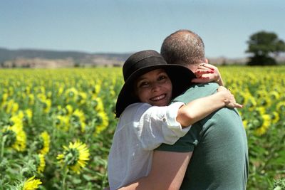 Couple embracing while standing in farm