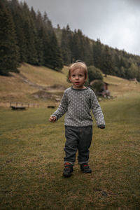 Portrait of cute girl standing on field