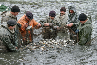 Men fishing in river