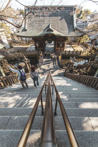 Rear view of people walking in temple