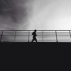 Low angle view of silhouette people against sky