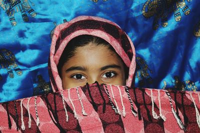 Close-up portrait of woman covering face