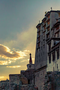 Low angle view of old building against sky during sunset