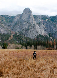 Man with horse on field against sky