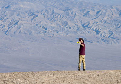 Man standing on snow covered landscape