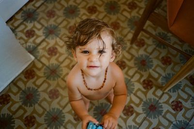 High angle view of baby boy on bed at home