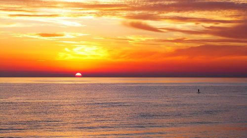 Scenic view of sea against orange sky