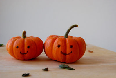 Close-up of jack o lantern on table against white background
