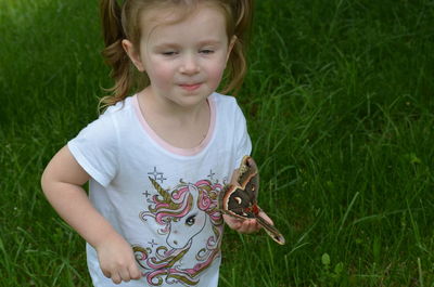 Portrait of cute girl standing on field