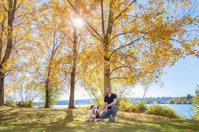 Woman with dog on plant during autumn