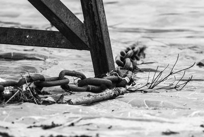 Close-up of rusty chain on beach