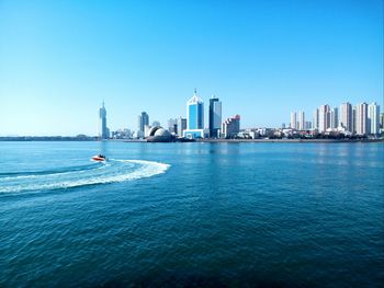 Scenic view of sea and buildings against sky