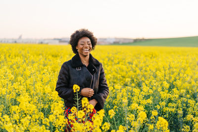 Portrait of smiling young woman in field