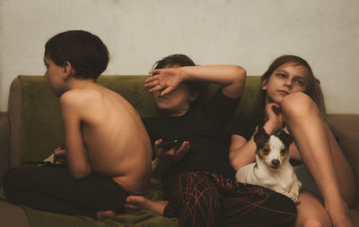 Siblings sitting at home