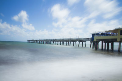 Pier over sea against sky