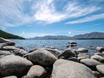 Rocks by sea against sky