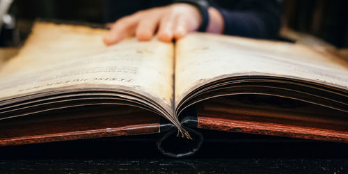 Close-up of hand on book