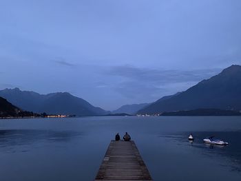 Scenic view of lake against sky at dusk