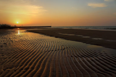 Scenic view of beach at sunset