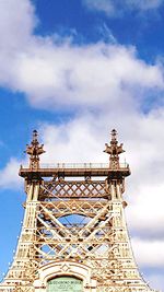 Low angle view of eiffel tower against cloudy sky