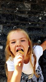 Close-up portrait of girl eating ice cream