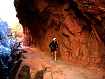 Man standing on rock in cave