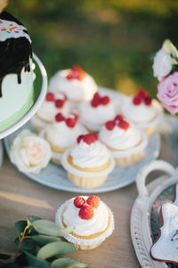 Bright raspberry cupcake and birthday cake on a table