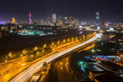 High angle view of city lit up at night