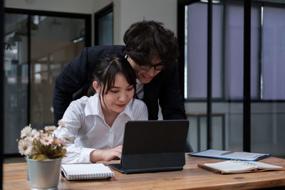 Young woman using laptop at table