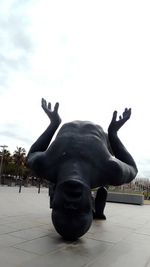 Close-up of horse statue against sky