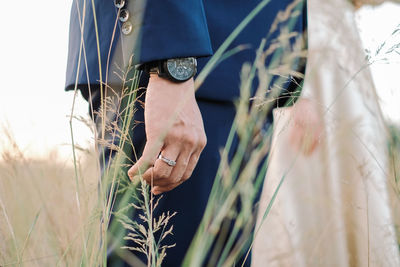 Midsection of woman standing by plants